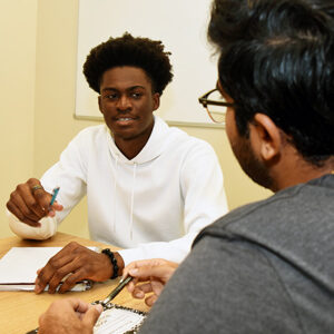 A student tutoring another student during a group study
