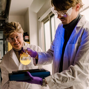 A teacher is instructing a student in a laboratory setting